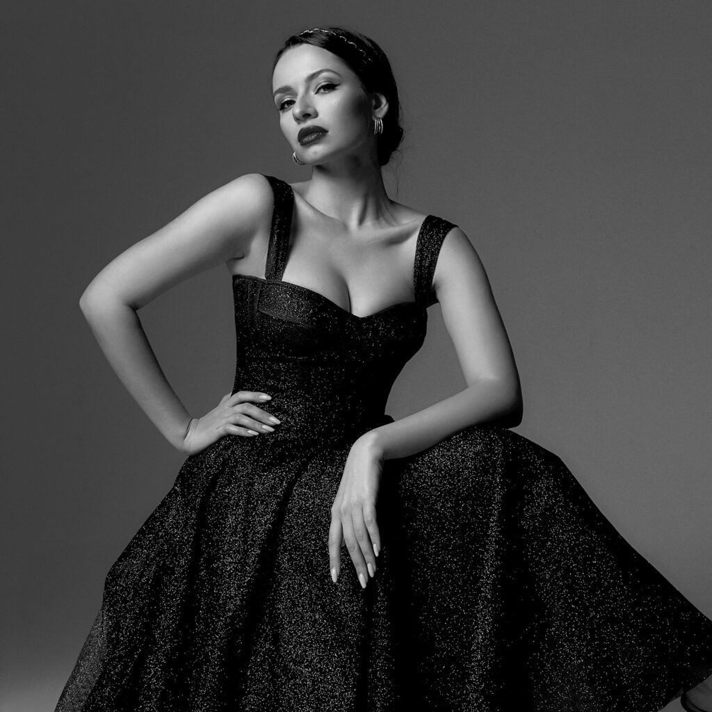 Elegant woman wearing a black evening gown photographed for Sudsies Dry Cleaning luxury garment care